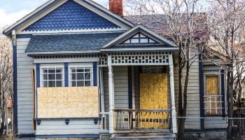 Old Boarded Up Home From Recession