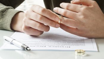 Woman taking off wedding ring