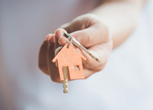 Female hand holding house key