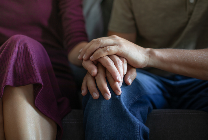 couple holding hands - How to tell your spouse you want a divorce in Howard County, MD