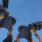 High school graduates holding up their graduation caps - Does child support end at 18 or high school graduation in Maryland?