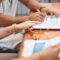 Couple, hands and sign of document, table and legal in office - are assets in a trust protected from divorce